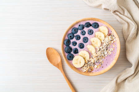 yogurt or yoghurt smoothie bowl with blue berry, banana and granola - Healthy food styleの写真素材