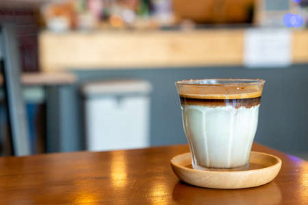 Dirty Coffee - A glass of espresso shot mixed with cold fresh milk in coffee shop cafe and restaurantの写真素材