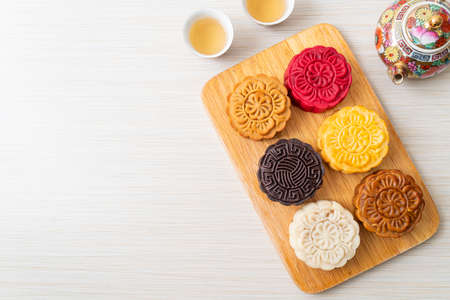 colourful Chinese moon cake with mixed flavour on wood plateの写真素材