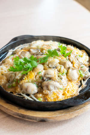 Oyster omelette with bean sprout on hot pan - Asian food style