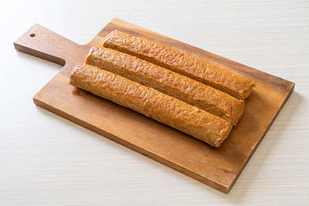 fried Chinese fish cake or fish ball line on wood board