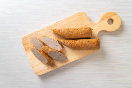 fried Chinese fish cake or fish ball line on wood board