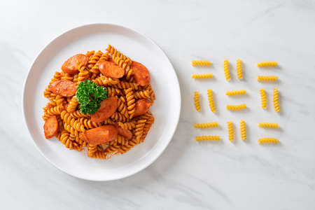 spiral pasta with tomato sauce and sausage - Italian food styleの写真素材