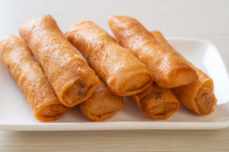 deep fried spring roll with sauce on white plateの写真素材