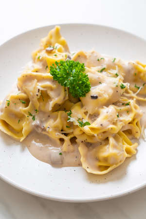 tortellini pasta with mushroom cream sauce and cheese - Italian food styleの写真素材