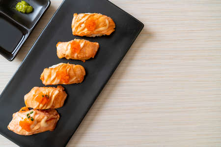 grilled salmon sushi on black plate - Japanese food styleの写真素材