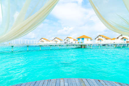 white arch with tropical Maldives resort and sea backgroundの写真素材