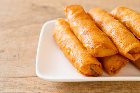 deep fried spring roll with sauce on white plate