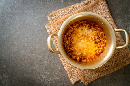 Korean spicy instant noodle bowl with mozzarella cheeseの写真素材