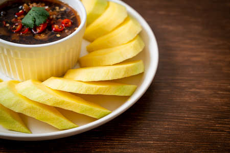fresh green and golden mango with sweet fish sauce dipping - Asian styleの写真素材