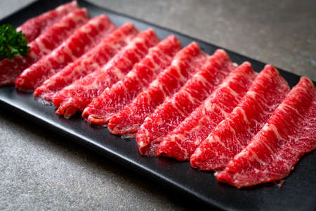 fresh beef raw sliced with marbled texture served for Sukiyaki and Shabu or Yakinikuの写真素材