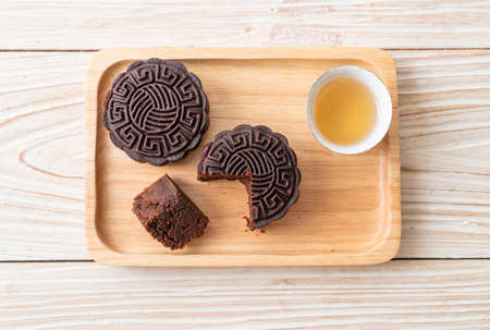 Chinese moon cake dark chocolate flavour on wood plate