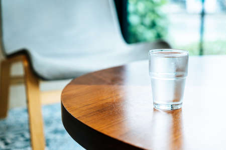 glass of water on wood tableの写真素材