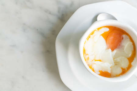 Soft-boiled eggs in white cup for breakfastの写真素材