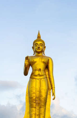 A golden buddha statue with sky on the mountain top at Hat Yai municipality public park, Songkhla Province, Thailandの写真素材