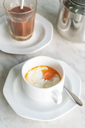 Soft-boiled eggs in white cup for breakfastの写真素材