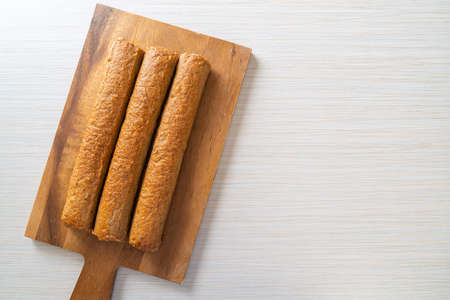 fried Chinese fish cake or fish ball line on wood board