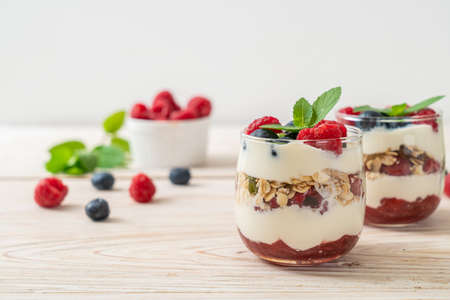 homemade raspberry and blueberry with yogurt and granola - healthy food styleの写真素材
