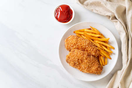 fried chicken breast fillet steak with French fries and ketchup