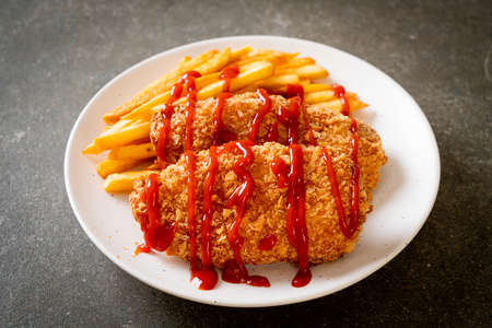 fried chicken breast fillet steak with French fries and ketchup