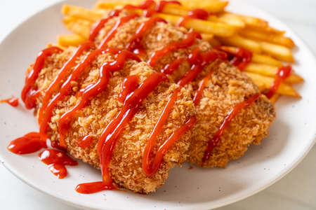 fried chicken breast fillet steak with French fries and ketchup