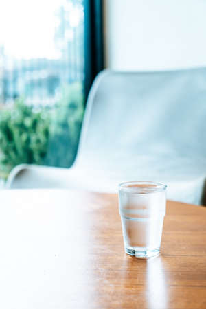 glass of water on wood tableの写真素材