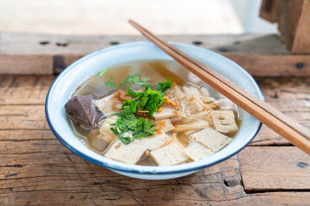 Vietnamese Rice Noodle Soup with pork and chicken on wood tableの写真素材