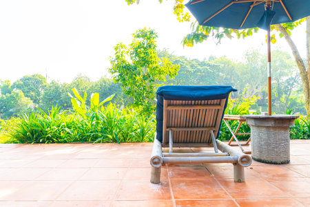 umbrella and pool bed around swimming pool with river viewの写真素材