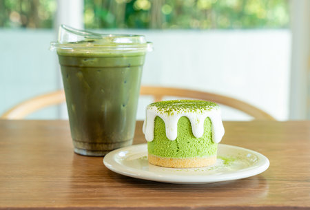 matcha green tea cheese cake with green tea cup on table in cafe restaurant