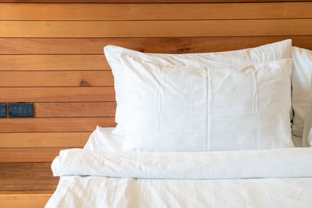 white pillow decoration on bed in bedroom interior