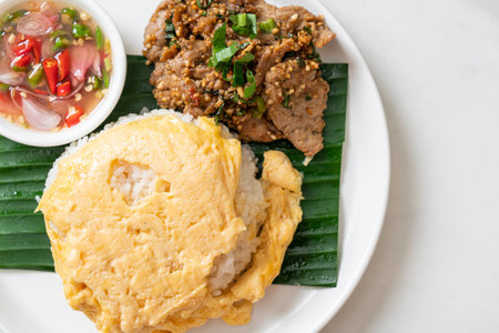 egg on topped rice with grilled pork and spicy sauce - Asian food styleの写真素材