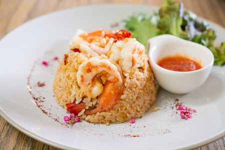 shrimps fried rice with salt egg on plateの写真素材