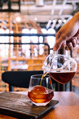 cold drip black coffee jar with glass and ice in coffee shop cafe and restaurantの写真素材