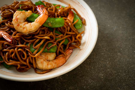 stir-fried yakisoba noodles with green peas and shrimps - Asian food styleの写真素材