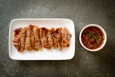 Grilled Pork Neck or Charcoal-boiled Pork Neck with Thai Spicy Dipping Sauceの写真素材