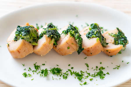 Chicken breasts stuffed with spinach and cheese on plateの写真素材