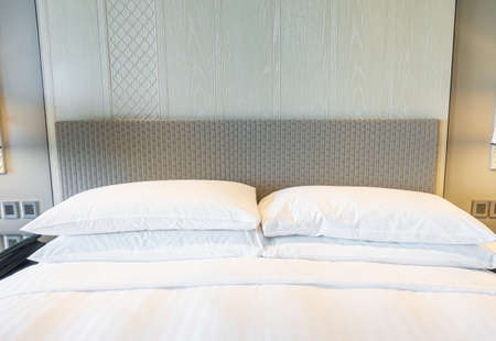 white pillows decoration on bed in bedroom interiorの写真素材