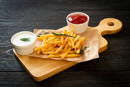 French fries or potato chips with sour cream and ketchupの写真素材