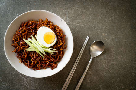 Korean Instant Noodle with Black Bean Sauce topped cucumber and boiled egg (Jajangmyeon or JJajangmyeon) - Korean food styleの写真素材