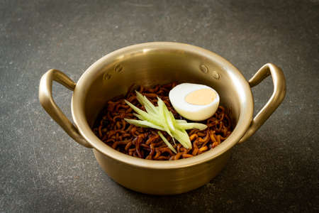 Korean Instant Noodle with Black Bean Sauce topped cucumber and boiled egg (Jajangmyeon or JJajangmyeon) - Korean food styleの写真素材