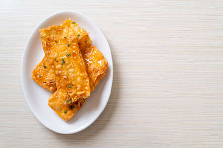 crispy roti with sugar on plateの写真素材