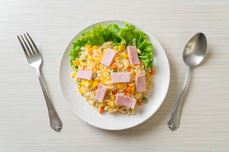 homemade fried rice with ham and mixed vegetable (carrot, green bean peas, carrot)の写真素材