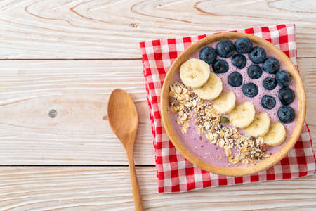 yogurt or yoghurt smoothie bowl with blue berry, banana and granola - Healthy food styleの写真素材