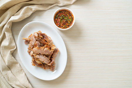 Grilled Pork Neck or Charcoal-boiled Pork Neck with Thai Spicy Dipping Sauceの写真素材