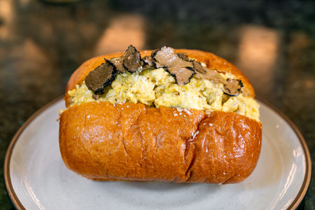 bun or bread with scrambled eggs and truffle mushroom