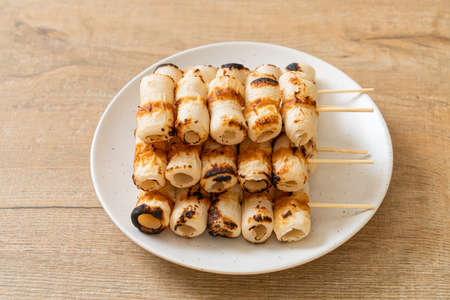 grilled tube shaped fish paste cake or tube squid skewer on plate