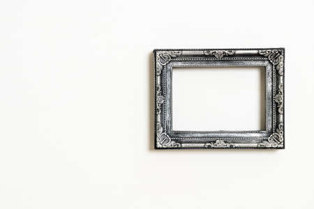 empty picture frame on white wall background with copy spaceの写真素材