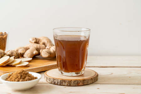 hot and sweet ginger juice glass with ginger roots - Healthy drink styleの写真素材
