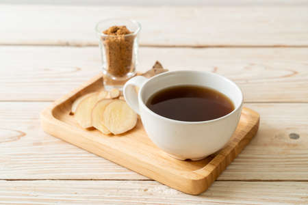 hot and sweet ginger juice glass with ginger roots - Healthy drink styleの写真素材