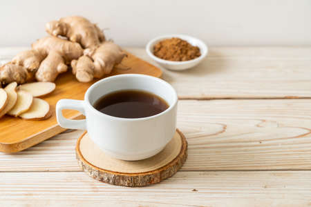 hot and sweet ginger juice glass with ginger roots - Healthy drink style